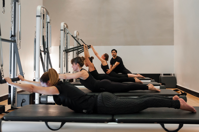 Clase de Pilates en grupo reducido sobre Reformer